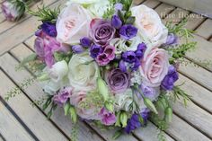 a bridal bouquet sitting on top of a wooden table