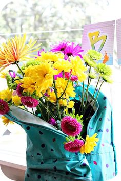 colorful flowers in a blue bag on a window sill