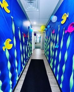 the hallway is decorated with blue and green fish