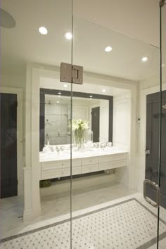 a bathroom with two sinks and a large mirror