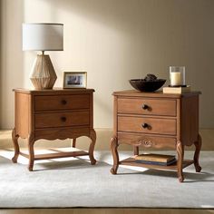 two wooden nightstands sitting next to each other on top of a carpeted floor