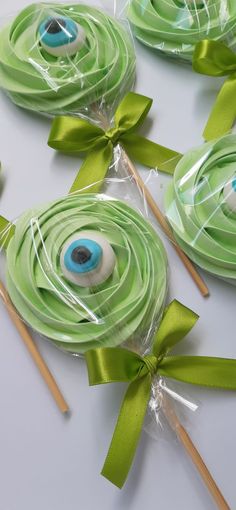 green lollipops wrapped in cellophane and decorated with an eyeball