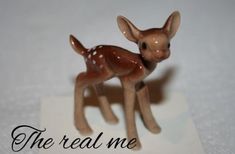 a small deer figurine sitting on top of a piece of paper that says the real me