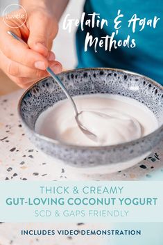 a person holding a spoon in a bowl of yogurt with the words thick & creamy gut - loving coconut yogurt