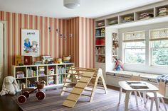 a child's playroom with bookshelves and toys