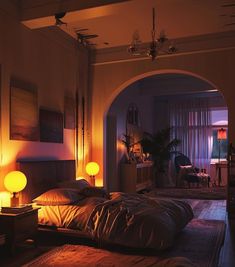 a dimly lit bedroom with an arched doorway