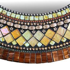 a mirror that is made out of wood and glass mosaics, with beads around the edges