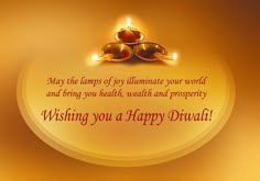 a happy diwali greeting card with two lit candles on the top of it