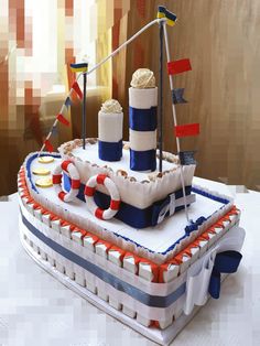 a cake made to look like a boat with flags on the front and sides, sitting on top of a table