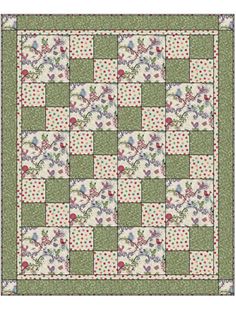 a green and white quilt with flowers on it