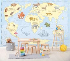 a child's room with an animal map on the wall and toys in the floor