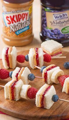 small marshmallows and strawberries on skewers with peanut butter and jelly