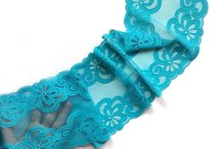 two pieces of blue lace with flowers on them