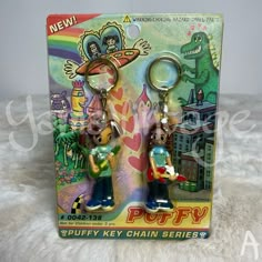 two key chains in the shape of cartoon characters