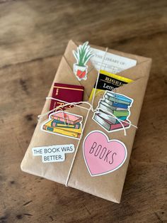 a brown paper bag filled with books on top of a wooden table