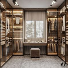 a walk in closet with glass doors and shelves