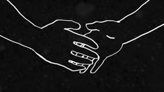 two hands holding each other in front of a black background with snow falling on the ground