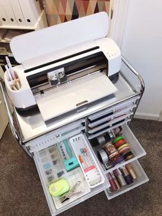 a sewing machine sitting on top of a table with lots of crafting supplies in it