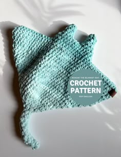 a crochet hat is laying on top of a white surface with the words crochet pattern below it