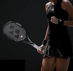 a woman holding a tennis racquet on top of a tennis court in front of a black background