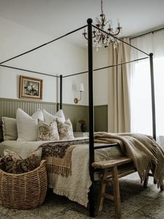 a bedroom with a four post bed and wicker baskets on the floor