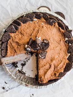 an oreo cookie pie with one slice taken out and the rest of it's crust removed