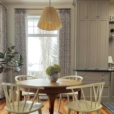 a dining room table with four chairs around it