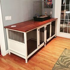 a dog kennel in the corner of a living room