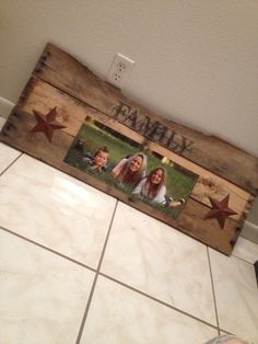 a wooden frame with two pictures on it and the word family written in large letters