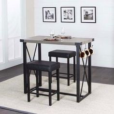 a table and two stools in a room