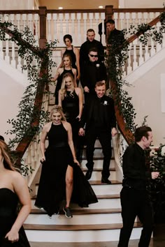 a group of people standing on top of a set of stairs in front of a staircase