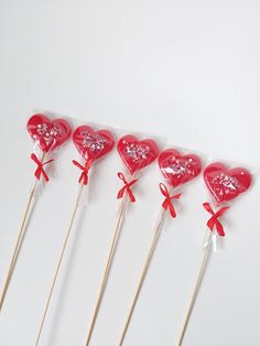 six heart shaped lollipops on sticks with bows and bowknots