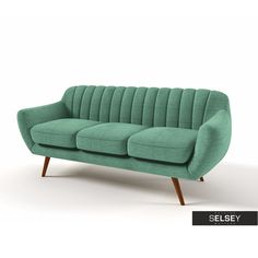 a green couch sitting on top of a white floor