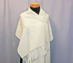 "Wrap this cozy mohair shawl around you for a touch of understated elegance.  It is hand woven of luxury mohair and wool to keep you nice and warm.  It measures a generous 20\" by 78\".  Dry clean.   Pin not included. All my shawls are hand woven in my studio from highest quality fibers." Handwoven Alpaca Shawl, Handmade Elegant Mohair Shawl, Elegant Handmade Mohair Shawl, Elegant White Poncho For Winter, Elegant White Winter Poncho, One Size Handwoven Alpaca Shawl, White Fringed Shawl For Winter, White Shawl Wrap Scarf, White Fringe Shawl For Winter