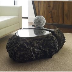 a living room with a table made out of rocks