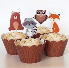 cupcakes with frosting and paper animals on top