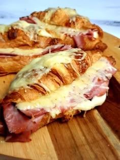 ham and cheese croissants on a wooden cutting board