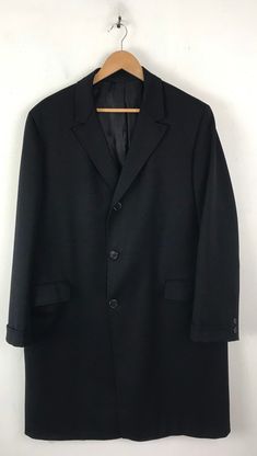 "-Description- >men's black wool overcoat >collared >three button front >two flap close pockets on the front >two buttons on the cuffs >lined >vent in the back >size large >perfect for a business coat! >condition: great >color(s): black >fabric(s): wool >brand: hymans clothes >care: dry clean -Measurements- >size: large ✩ all measurements are taken with the item laying flat & some sizes are estimates so please check measurements ✩ chest: 48\" / 12 Black Single Button Business Outerwear, Black Sport Coat With Single Button And Lapel Collar, Classic Black Sport Coat With Hidden Button Closure, Classic Black Sport Coat With Hidden Buttons, Black Sport Coat With Hidden Button For Business, Black Wool Sport Coat With Single Button, Black Single Breasted Sport Coat For Business, Formal Black Pea Coat With Double Button Closure, Black Single-breasted Sport Coat For Business