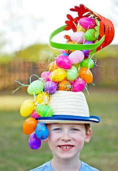 a young boy wearing a hat with balloons on it and the words diy easter hat