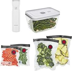 four bags of vegetables are sitting next to an electric gadget and thermometer