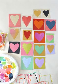 the paper hearts are cut into squares and placed on top of each other in different colors