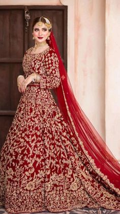 a woman in a red and gold bridal gown