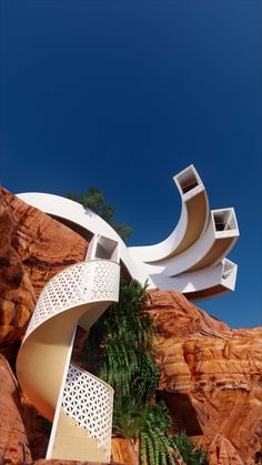 an unusual building on the side of a mountain