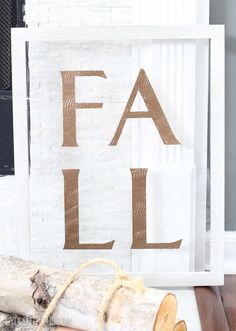 a piece of wood sitting on top of a wooden floor next to a sign that says fal