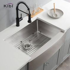 a stainless steel kitchen sink under a faucet with a drainer and strainer