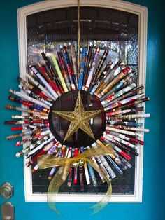 a star wreath made out of baseball bats hangs on the front door's window