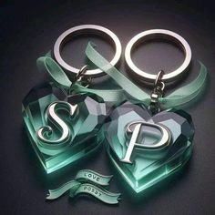 three heart shaped key chains with the letter p on them, sitting next to each other