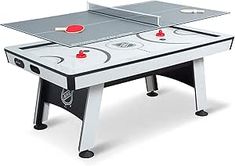 a ping pong table with two paddles on it and an air hockey board