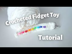 the crocheted finger toy is next to a ball of yarn