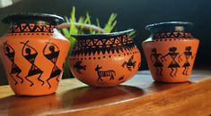 three vases sitting on top of a wooden table